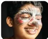 A performer wearing symbolic make-up, where painted markings on the face carry meaning about character, identity or state of mind