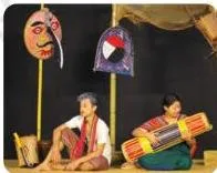 A stage scene in which ordinary props take on the weight of characters, carrying the play's meaning by themselves