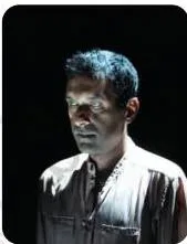 An actor lit from below by a light placed on the stage floor, an unusual angle used for special effects