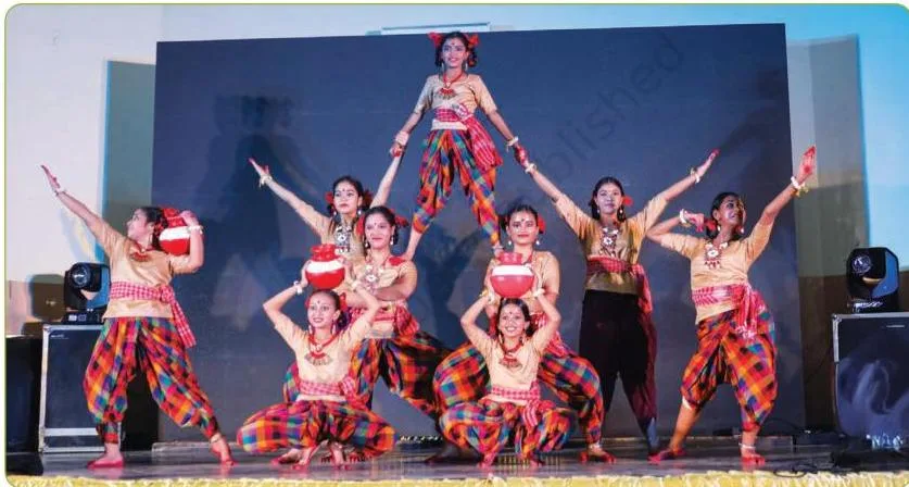 A dancer taking a bow and smiling at the end of a performance, the closing image of A Presentation of Dance and Choreography Class 8