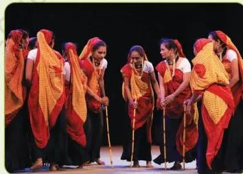 Tippani dancers from Gujarat moving together while striking rhythmic sticks in a circular pattern, the whole group and song gaining speed