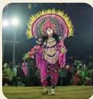 A Purulia Chhau dancer in full costume, its elaborate mask and attire leading the eye to the abhinaya of appearance