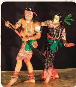 A Seraikela Chhau dancer in the Boat Man pose, with a curved stance that visually suggests the act of rowing a boat