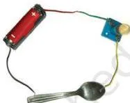 A conduction tester made of a cell, a lamp and two free wire ends, used to test whether a material between the ends lets current pass