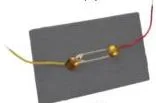 A homemade switch built from a safety pin and two drawing pins on cardboard, shown in the open OFF position and the closed ON position