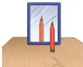 A pen standing upright in front of a plane mirror, with its same-sized image appearing upright behind the mirror