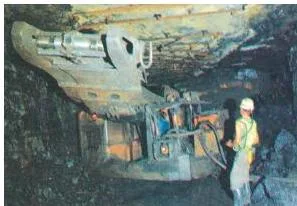 View from inside a coal mine showing the dark excavated underground working where coal is cut and loaded