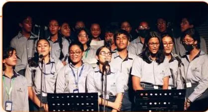 School students singing together in a group, illustrating chaugun, where each beat carries four bols in the taal speed activity.