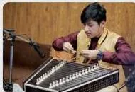 An artist playing the ektara, an instrument to listen for in the chapter's instrumental music activities