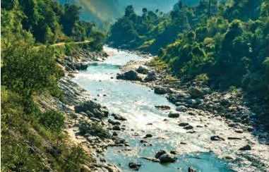 A river flowing between forested hills, a renewable resource as long as glaciers and forests continue to feed it