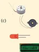 Sensor modules, a microcontroller and a motor toy arranged together, representing the input, process and output stages of automation