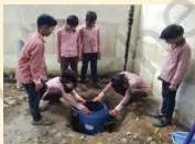 Students digging a soak pit in the ground, the project method for draining excess water so mosquitoes cannot breed