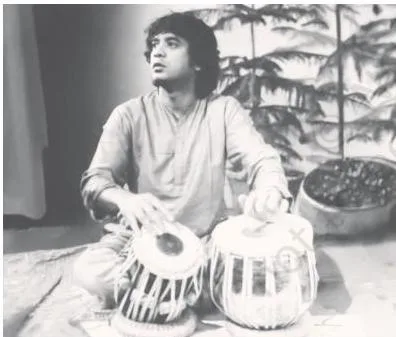 Portrait of tabla maestro Ustad Zakir Hussain (1951–2024), whose profile closes the tala section of the chapter
