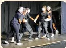 Performers acting in mime while instrumental background music suits the situation of the scene without lyrics