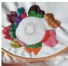 Examples of textile artwork created by students from cloth, thread and fibre