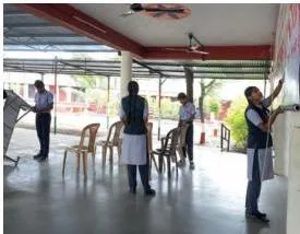 A school event space being arranged with clean, organised seating and materials, showing how the physical environment supports a service