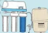 Close-up of an RO water filter's specification label showing its water consumption, about 3 litres wasted for every 1 litre treated