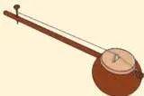 An ektara, a simple one-stringed musical instrument made from bamboo, a coconut shell or a hollow cylinder, resting on a surface