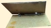 A small hinge prototype made by piercing pieces of old wire through cardboard, showing how a moving part can be modelled cheaply